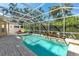 Beautiful, screened-in pool with a brick patio and lush landscaping, perfect for outdoor entertaining at 6032 36Th E Ct, Ellenton, FL 34222