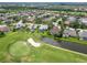 Overhead view showcasing backyard pools, landscaping, a pond, and a golf course highlighting community living at 664 Planters Manor Way, Bradenton, FL 34212