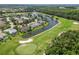 Beautiful aerial of golf course community with serene ponds, trees, and residential landscaping at 664 Planters Manor Way, Bradenton, FL 34212
