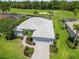 Aerial view of a beautiful home with a well-manicured lawn on a golf course at 664 Planters Manor Way, Bradenton, FL 34212