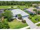 Aerial view of a beautiful home with a well-manicured lawn on a golf course at 664 Planters Manor Way, Bradenton, FL 34212