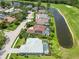 Aerial view of a neighborhood community on a golf course and lake at 664 Planters Manor Way, Bradenton, FL 34212