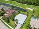 Aerial view of a neighborhood community on a golf course with mature trees and landscaping at 664 Planters Manor Way, Bradenton, FL 34212