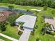 Aerial view of a beautiful home with a well-manicured lawn on a golf course at 664 Planters Manor Way, Bradenton, FL 34212