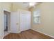 Bright bedroom features ceiling fan, wood floors, and closet for ample storage at 664 Planters Manor Way, Bradenton, FL 34212