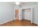 Comfortable bedroom with hardwood floors, ceiling fan, and closet at 664 Planters Manor Way, Bradenton, FL 34212