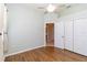 Bright bedroom with hardwood floors, ceiling fan, and closet at 664 Planters Manor Way, Bradenton, FL 34212