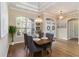 Inviting dining room with a large window and double doors offering ample natural light at 664 Planters Manor Way, Bradenton, FL 34212