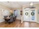 Inviting dining area with a wooden table, gray upholstered chairs, and decorative lighting at 664 Planters Manor Way, Bradenton, FL 34212