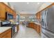 Well-appointed kitchen featuring stainless steel appliances and ample counter space, with a view to breakfast nook at 664 Planters Manor Way, Bradenton, FL 34212