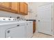 Laundry room with washer, dryer, utility sink, and storage cabinets at 664 Planters Manor Way, Bradenton, FL 34212