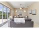 Living room with sofa, ceiling fan, and sliding glass doors to the outside at 664 Planters Manor Way, Bradenton, FL 34212