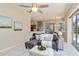 Comfortable living room with view of the kitchen, dining area, and access to the pool at 664 Planters Manor Way, Bradenton, FL 34212