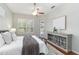 Lovely main bedroom with plush bed, shutters, ceiling fan, and backyard access at 664 Planters Manor Way, Bradenton, FL 34212