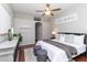 Stylish main bedroom with a ceiling fan, hardwood floors, and modern decor at 664 Planters Manor Way, Bradenton, FL 34212