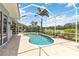Sparkling pool within a screened enclosure, complete with a patio and views of the green golf course at 664 Planters Manor Way, Bradenton, FL 34212