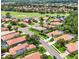 Community aerial view features homes with red tile roofs, lush landscaping, and a golf course nearby at 706 Misty Pond Ct, Bradenton, FL 34212