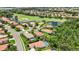 Aerial view of a community featuring lush landscaping, a golf course, and waterfront properties at 706 Misty Pond Ct, Bradenton, FL 34212