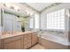 Bathroom features a glass block window, soaking tub, and a glass enclosed shower at 706 Misty Pond Ct, Bradenton, FL 34212
