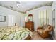 Bright bedroom features a ceiling fan, light wood floors, and a decorative wallpaper border at 706 Misty Pond Ct, Bradenton, FL 34212