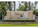 Stone entrance sign for Waterlefe Golf & River Club with lush landscaping and manicured lawn at 706 Misty Pond Ct, Bradenton, FL 34212