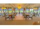 Elegant dining room featuring well spaced tables set for service, light wood floors and neutral decor at 706 Misty Pond Ct, Bradenton, FL 34212