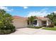 Charming single-story home boasts a red tile roof, manicured landscaping, and a two-car garage at 706 Misty Pond Ct, Bradenton, FL 34212