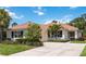 Lovely single-story home with a red tile roof, well-kept landscaping, and an inviting front entrance at 706 Misty Pond Ct, Bradenton, FL 34212