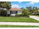 Charming home exterior featuring a beautiful terracotta roof and lush landscaping at 706 Misty Pond Ct, Bradenton, FL 34212