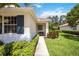 Inviting home entrance with a cozy bench, lush greenery, and a well-maintained walkway at 706 Misty Pond Ct, Bradenton, FL 34212