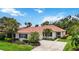 Charming single-story home with a tile roof, beautiful landscaping, and a spacious concrete driveway at 706 Misty Pond Ct, Bradenton, FL 34212
