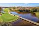Scenic golf course view with a bridge over a tranquil pond with beautiful, mature trees surrounding the course at 706 Misty Pond Ct, Bradenton, FL 34212