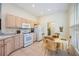 Kitchen with wooden cabinets, white appliances, and eat-in dining area at 706 Misty Pond Ct, Bradenton, FL 34212