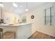 Bright eat-in kitchen with breakfast bar, modern lighting, and tile floors at 706 Misty Pond Ct, Bradenton, FL 34212