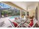 Enjoy the pool and landscaping from this covered lanai, ideal for entertaining at 706 Misty Pond Ct, Bradenton, FL 34212