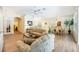 Spacious living room with wood floors, a bar, a dining table, and comfortable seating for entertaining at 706 Misty Pond Ct, Bradenton, FL 34212