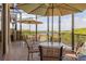 Inviting outdoor patio with tables, umbrellas, and scenic water views at 706 Misty Pond Ct, Bradenton, FL 34212