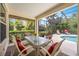 Relaxing screened patio with outdoor seating and a view of the private pool and landscaping at 706 Misty Pond Ct, Bradenton, FL 34212