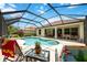 Screened-in pool area with a hot tub, lounge chairs, and a lovely outdoor dining set at 706 Misty Pond Ct, Bradenton, FL 34212