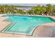 Beautiful pool deck with lounge chairs, overlooking the water, set amongst lush landscaping at 706 Misty Pond Ct, Bradenton, FL 34212