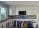 Kitchen with newly renovated backsplash, white cabinets and stainless microwave at 730 Spanish S Dr # 99, Longboat Key, FL 34228