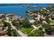 Aerial view showcasing waterfront property with lush landscaping, pool, and prime waterfront access at 7614 Peninsular Dr, Sarasota, FL 34231