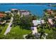 Waterfront estate with lush landscaping, a private pool, and stunning views of the bay at 7614 Peninsular Dr, Sarasota, FL 34231