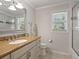 Bathroom with granite countertop, vanity, framed mirror, and glass enclosed shower at 7614 Peninsular Dr, Sarasota, FL 34231