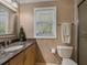 Bathroom with a granite countertop and toilet at 7614 Peninsular Dr, Sarasota, FL 34231