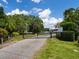 View of a gated community entrance with lush landscaping and a waterway beyond at 7614 Peninsular Dr, Sarasota, FL 34231
