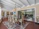 Dining area with water views, tile floors, natural light and seating for six looking into the living room at 7614 Peninsular Dr, Sarasota, FL 34231