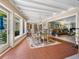 Dining area with water views, tile floors, natural light and seating for six with a large open entryway at 7614 Peninsular Dr, Sarasota, FL 34231