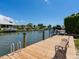 Wooden dock with benches overlooking a waterway, perfect for relaxing and enjoying the waterfront scenery at 7614 Peninsular Dr, Sarasota, FL 34231
