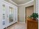 Bright foyer featuring tiled flooring, and a decorative glass front door at 7614 Peninsular Dr, Sarasota, FL 34231